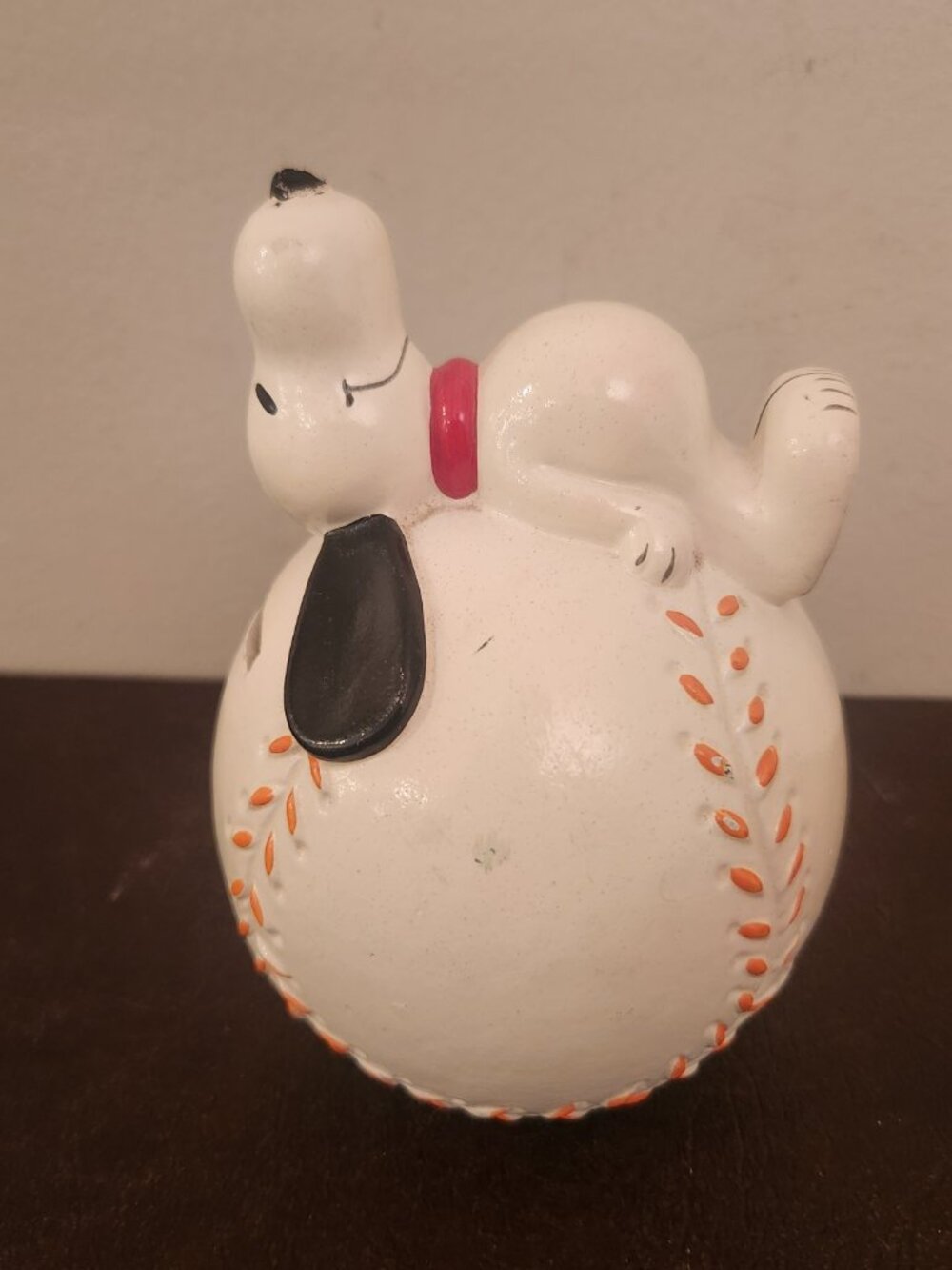 Vintage 1966 Peanuts Snoopy sleeping on a baseball and softball coin piggy bank